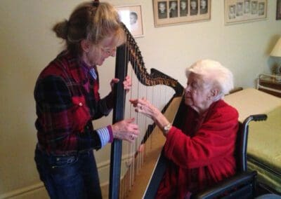 Harpist Martha Lawrance working with a patient